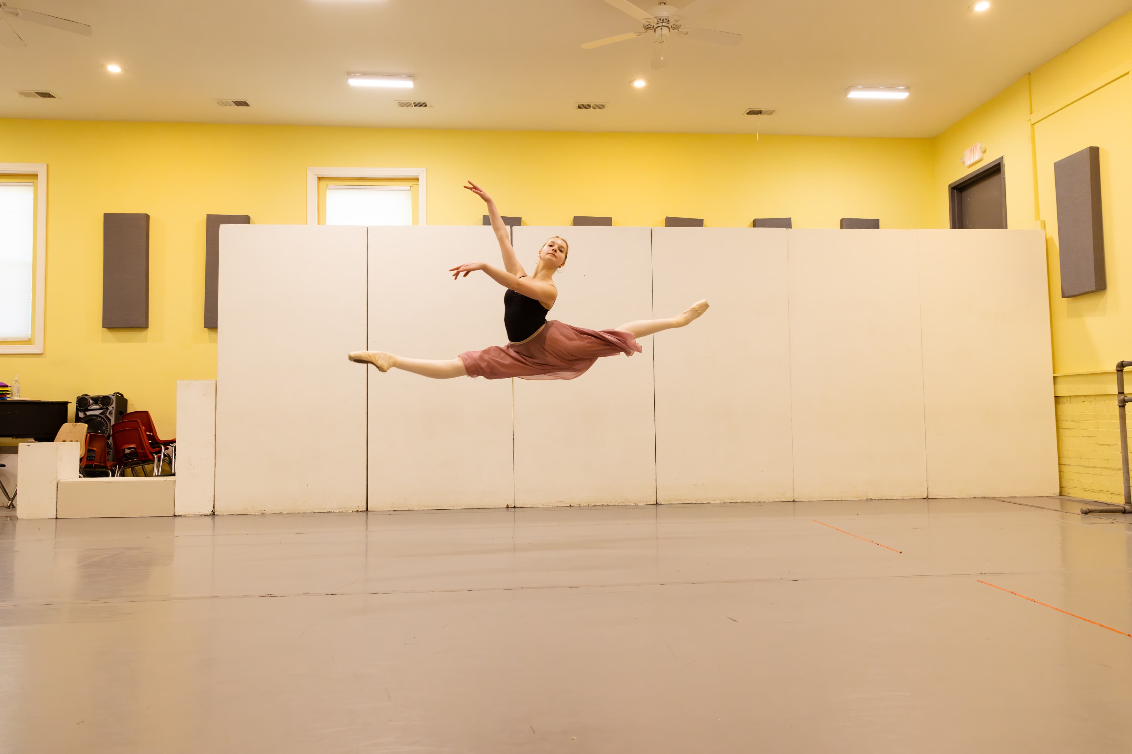 Dancer mid grand jeté in the studio