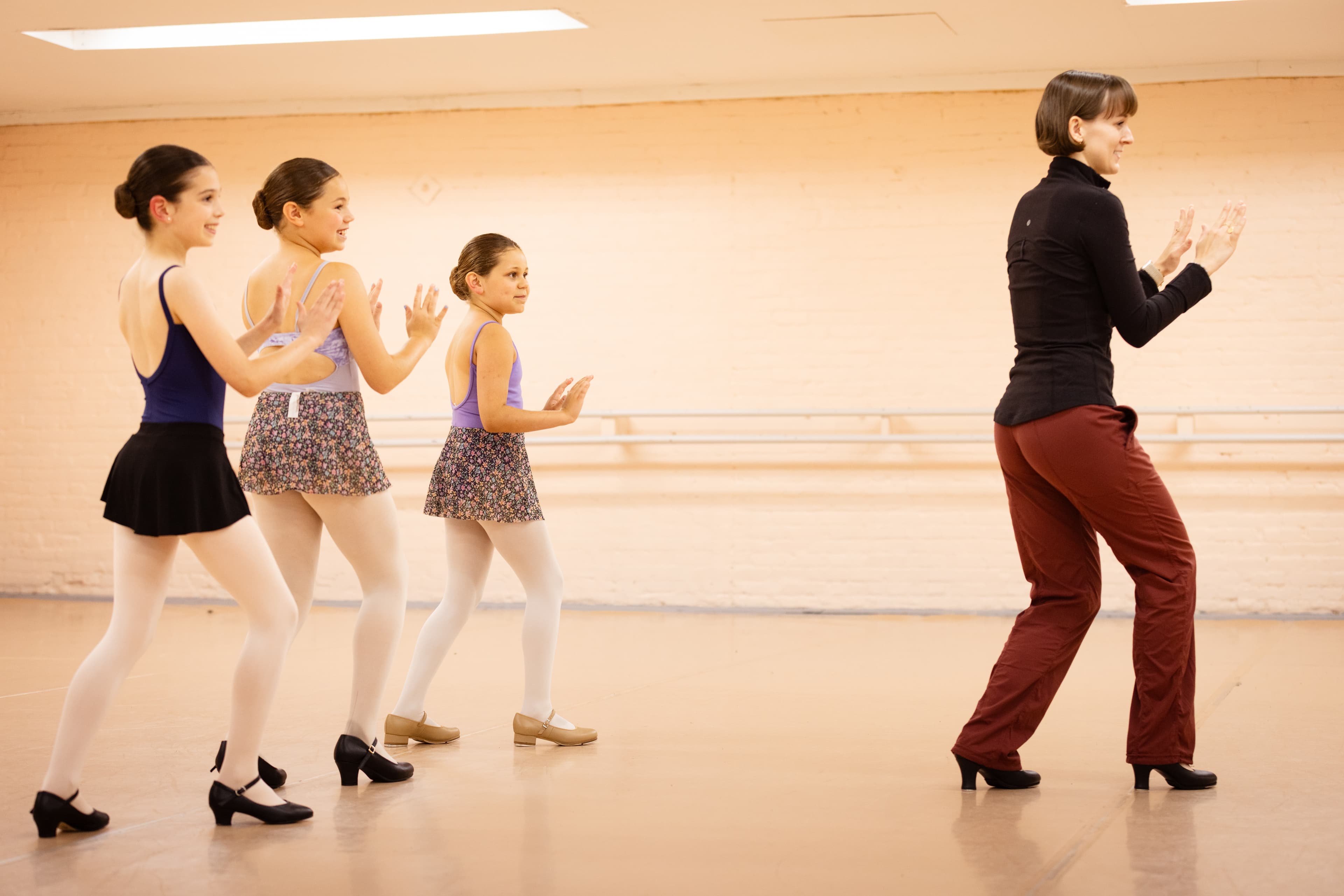 Tap class with instructor and young students