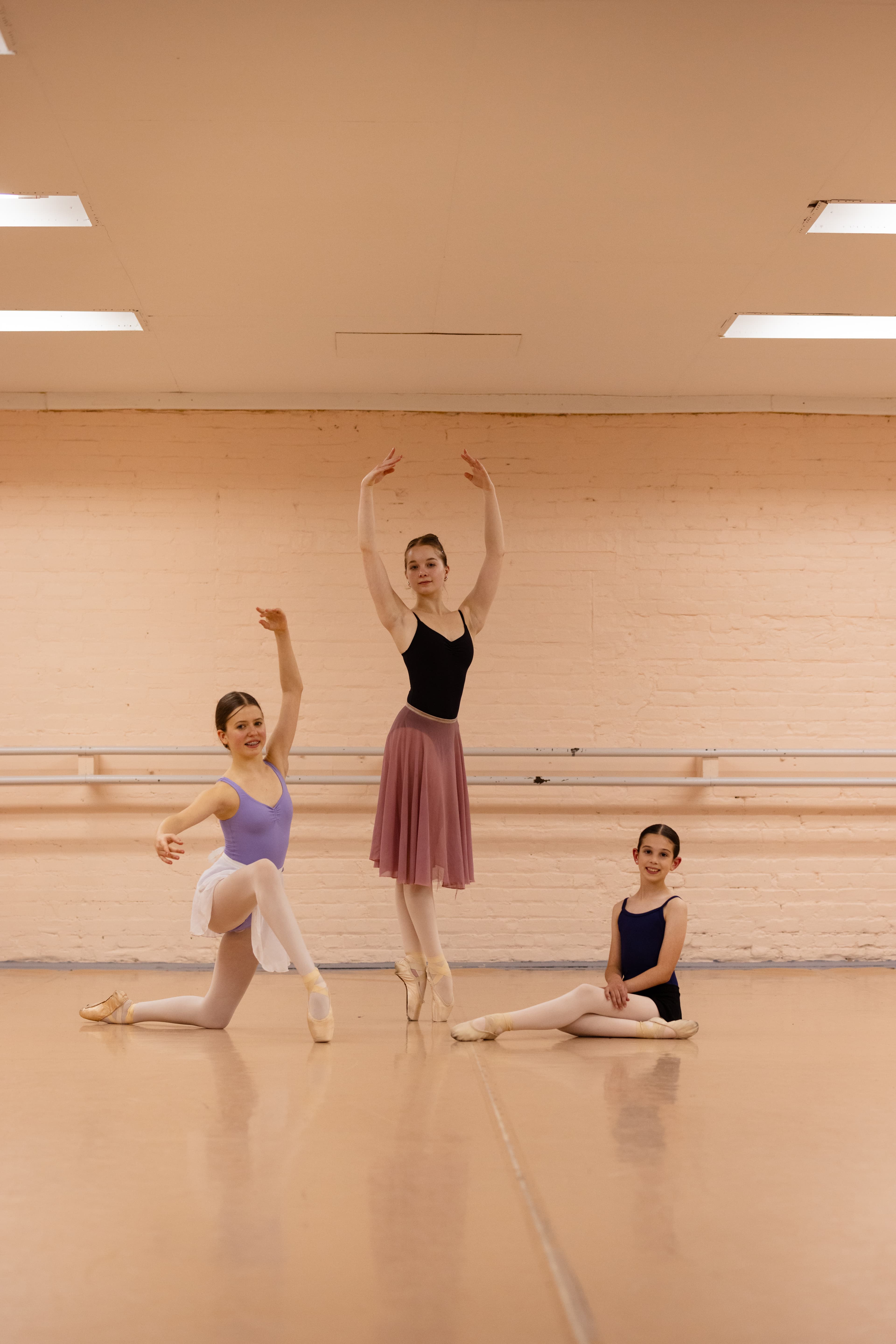 Three ballet dancers posing in the studio