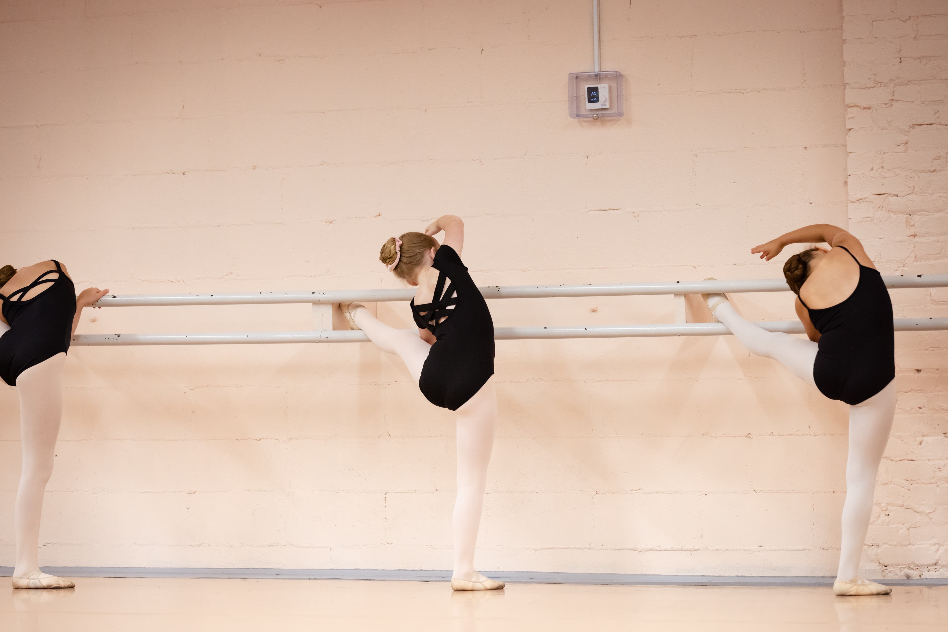 Three dancers at the barre