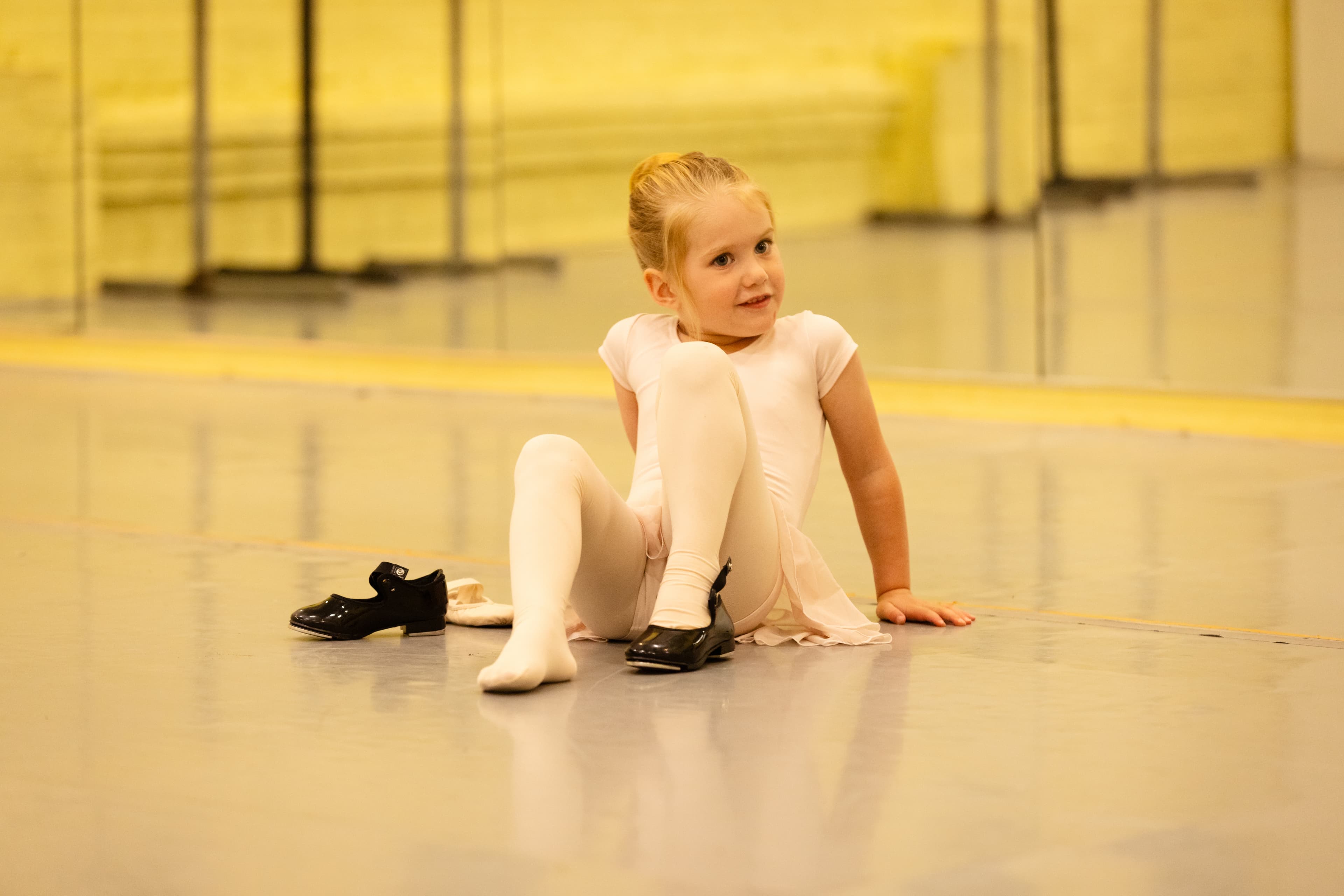 Young dancer trying on tap shoes
